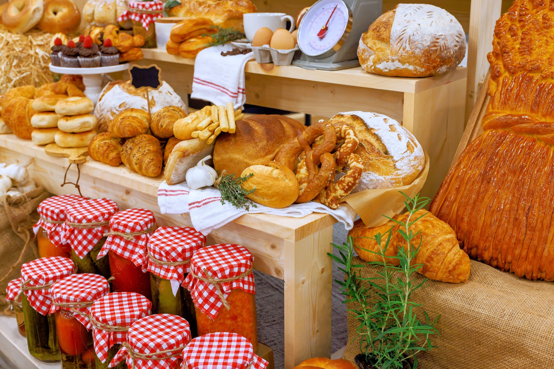 Bakery display showcasing fresh bread, pastries, homemade preserves at local market